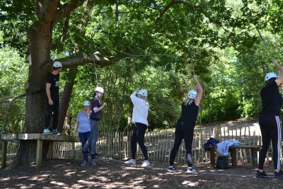People traversing a rope bridge