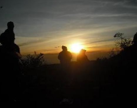 People on a hike as the sun is setting