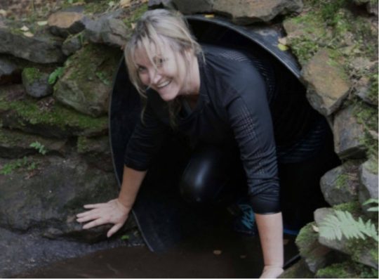 A woman emerging from a tunnel