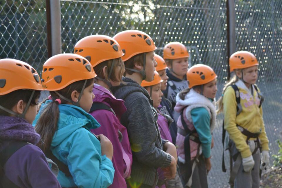 A row of children wearing helmets