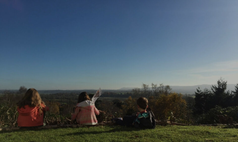 3 children sat on the grass