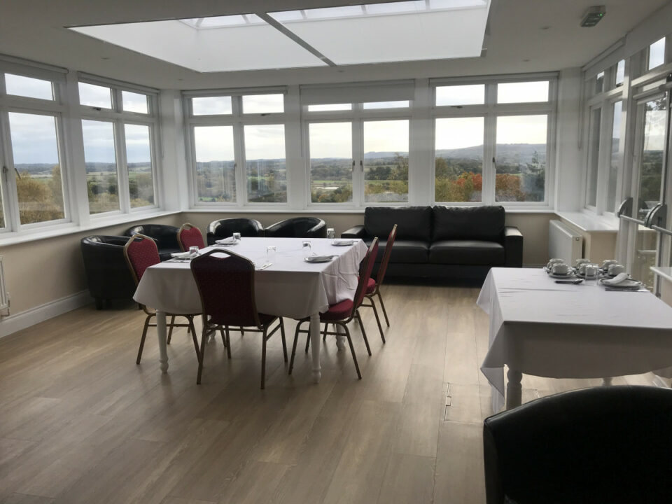 A table set up for a meal in a room with lovely views